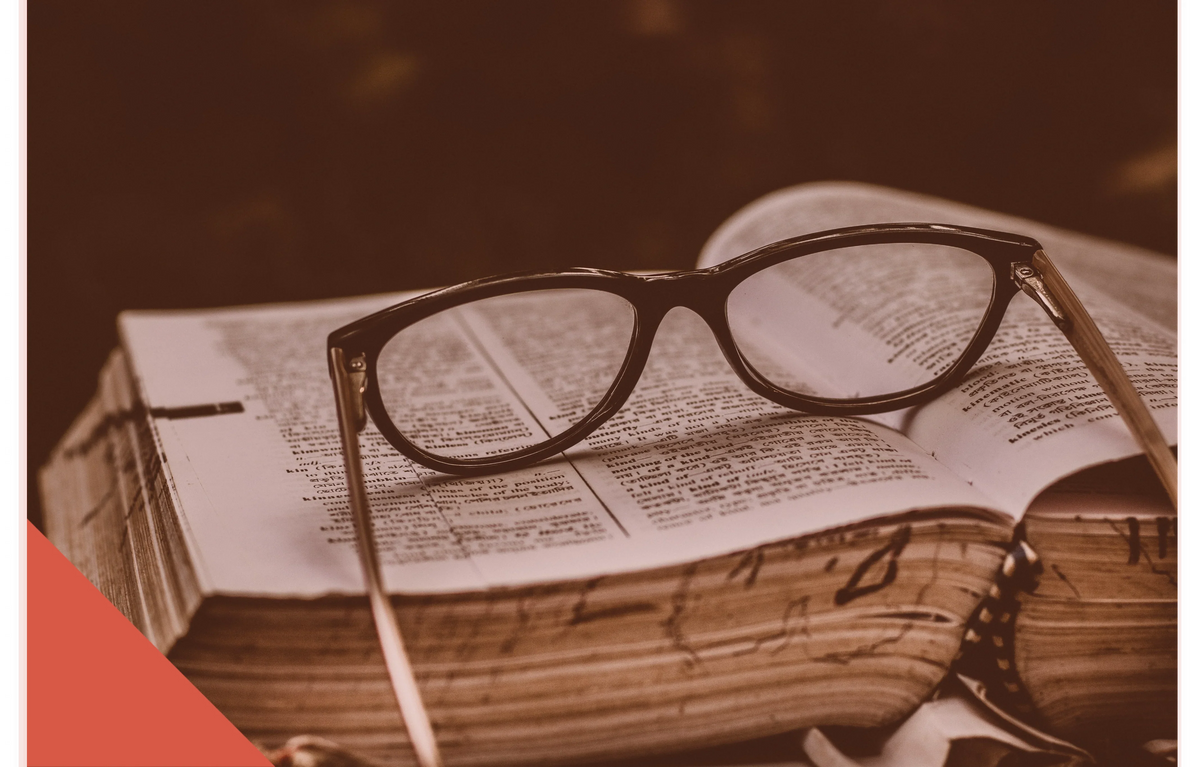 black-spectacles-otop-an-open-book 1