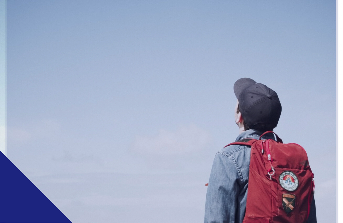 boy-with-hat-and-red-bag-looking-up-1 1